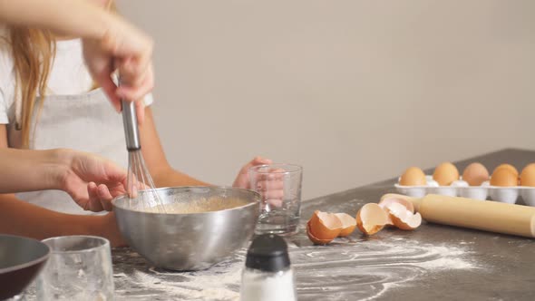 Funny Mother and Daughter Making Dough for Baking