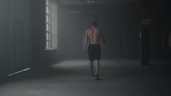 Man Walking in Building After Workout