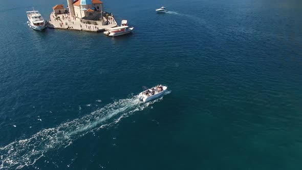 Boat with Tourists Sails Past the Island of Gospa Od Skrpjela Montenegro