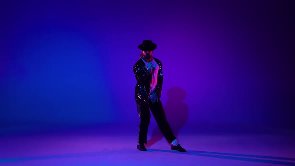 Young Stylish Teenager Is Showing Dance Moves. Isolated Over Blue Background