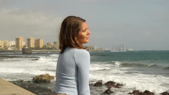 Beautiful Model Sitting by the Beach with a Beautiful View of the Ocean Waves