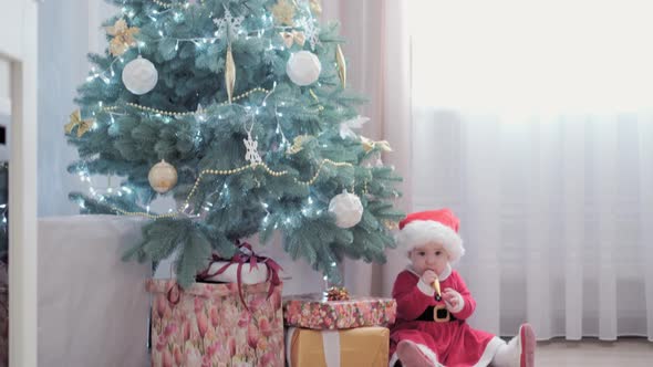 Authentic Cute Happy Joy Chubby Infant Girl Wearing Santa Hat and Red Dress Smile Play Have Fun