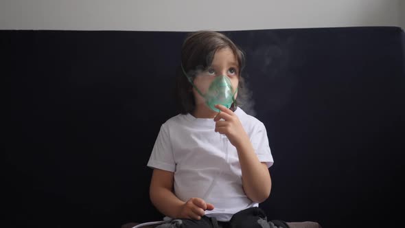 Boy Child Breathes Inhalation Through a Mask is Treated for Allergies