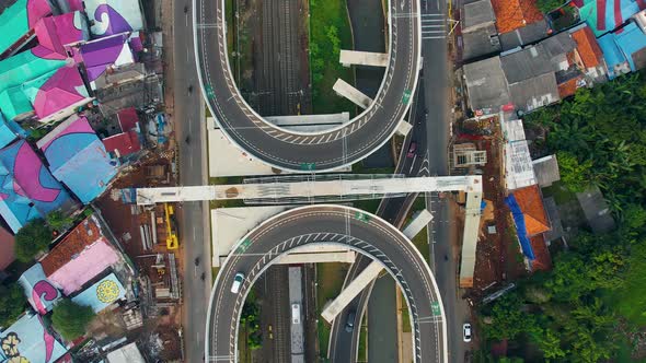 Aerial view of infinity sign traffic junction cross road with car transport.