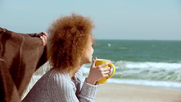 Beautiful Couple Hugging at the Beach Watching the Sea