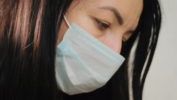 Portrait of Young Millennial Woman Cover Her Face Wearing Facial Medical Blue Mask