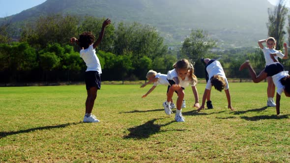 Children performing cart wheel during race