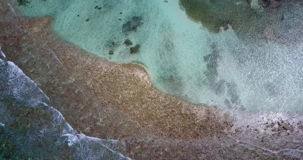 Daytime drone copy space shot of a white sand paradise beach and aqua blue ocean background in high 