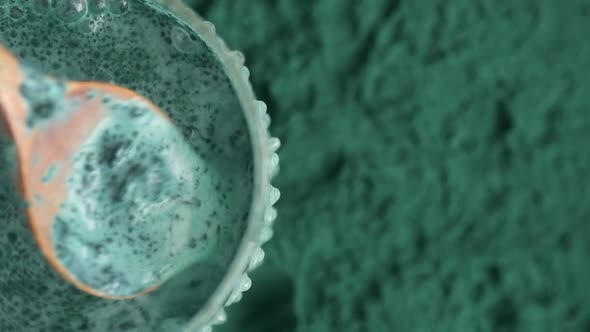 Glass of milk with spirulina powder view from the top