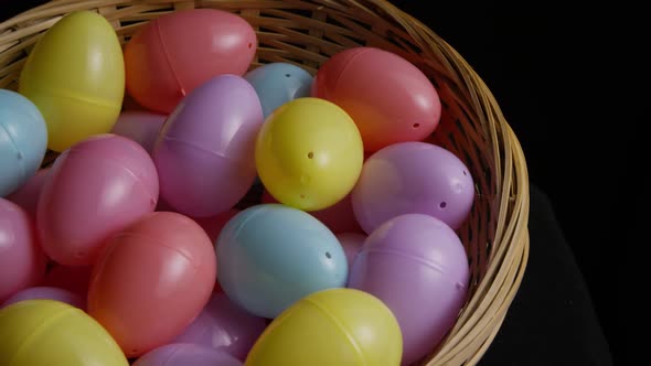 Rotating shot of Easter decorations and candy in colorful Easter grass 