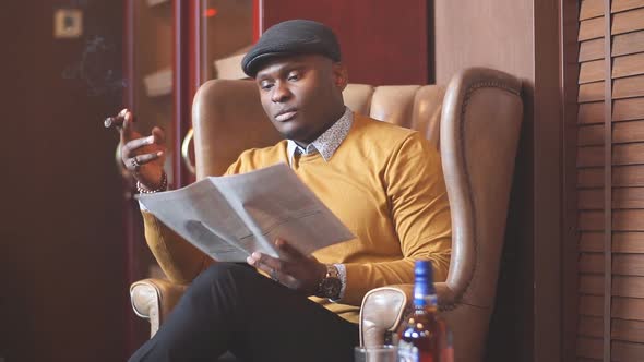 Black man smoking cigar portrait with hat.