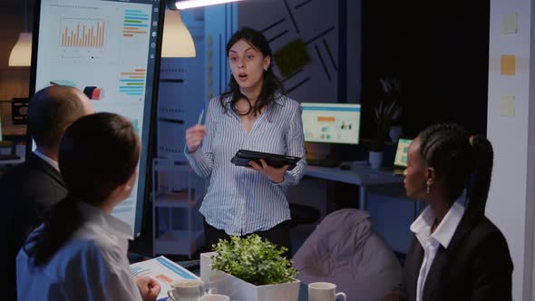 Workaholic Focused Businesswoman Explaining Management Solution Pointing Strategy on Monitor