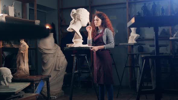 Art Studio with a Female Sculptor Working on a Bust