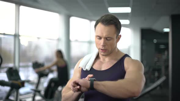 Athlete Man Checking Burned Calories in Smart Watch After Workout, Innovation