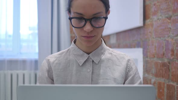 Hispanic Woman Working on Laptop in Office, Close Up