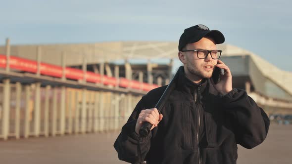 A Man in a Police Uniform is Walking and Talking on the Phone