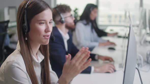 Close Up Portrait Woman of a Technical Customer Support Specialist Talking on a Headset While