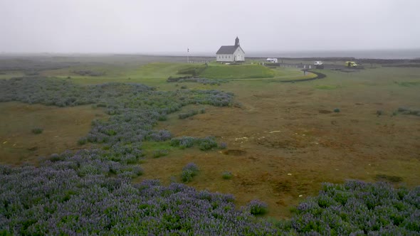 Strandarkirkja church in Iceland with drone video low and moving forward.