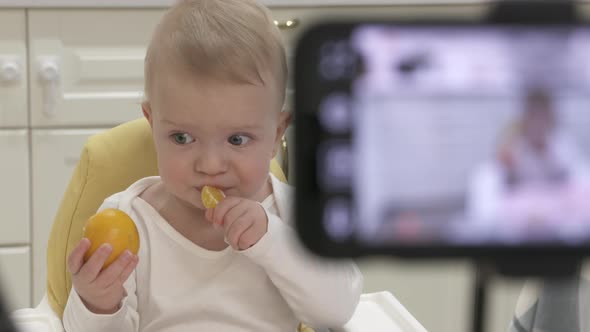 Parents Record Video on Smartphone of Kid in High Chair at Home Recording with Mobile Phone and Ring