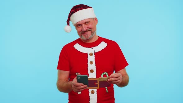 Man in Christmas Tshirt Using Credit Bank Card Smartphone While Transferring Money Shopping Online