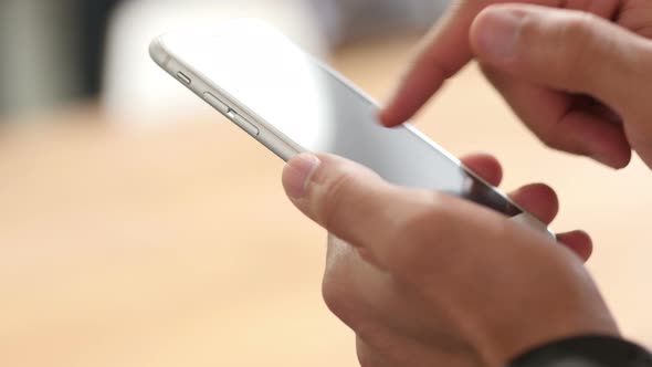 Close Up of Hand Using Smartphone