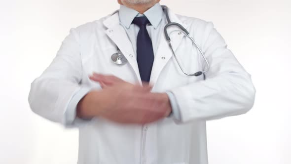 Doctor Stands in the Studio and Crosses Arms on Chest