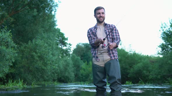 Fisherman with Fishing Rod on the River