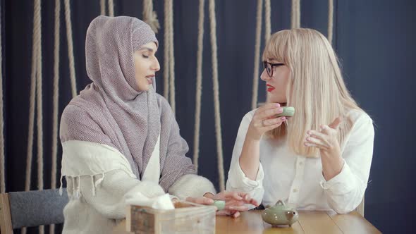 Two Women Having a Conversation in a Cafe