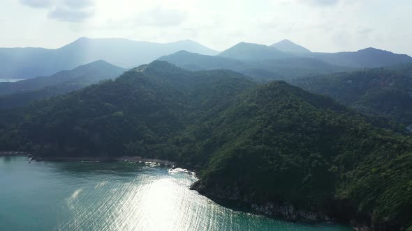 Mistery mountains and sea coast. Sunrays coming out through the heacy clouds. Thailand