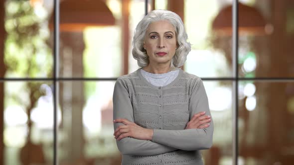 Old Senior Lady with Folded Arms Showing Silence Gesture