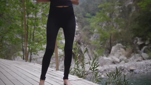 Yoga By the Mountains  a Woman in Black Clothes Doing Gymnastics Exercises