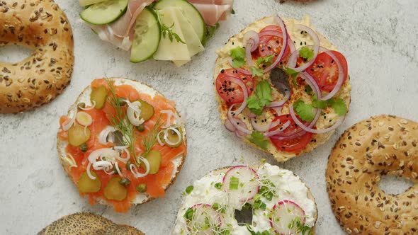 Homemade Bagel Sandwiches with Different Toppings, Salmon, Cottage Cheese, Hummus, Ham, Radish