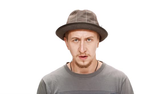 Annoyed Young Handsome Man in Hat Over White Background