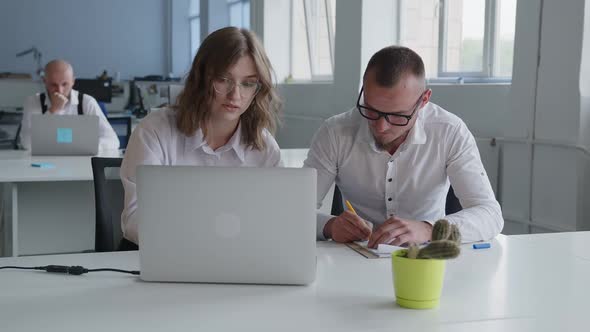 Girl Shows to Man How to Do Online Work