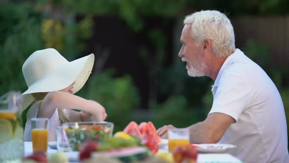 Girl Telling Exciting Story to Grandfather, Family Fooling Around Together