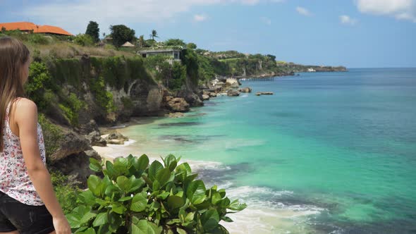 Girl Standing on a Cliff and Looking at the Sea. Bali, Indonesia