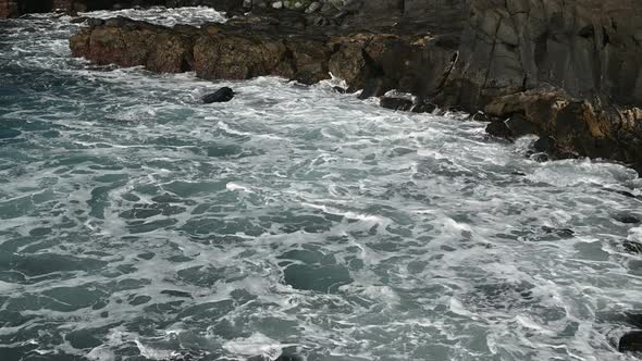 White Foamy Breaking Waves on the Beach with Black Volcanic Sand on Tenerife