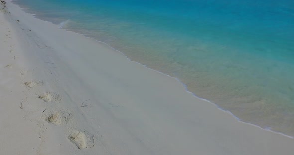 Wide angle aerial clean view of a summer white paradise sand beach and blue ocean background in colo