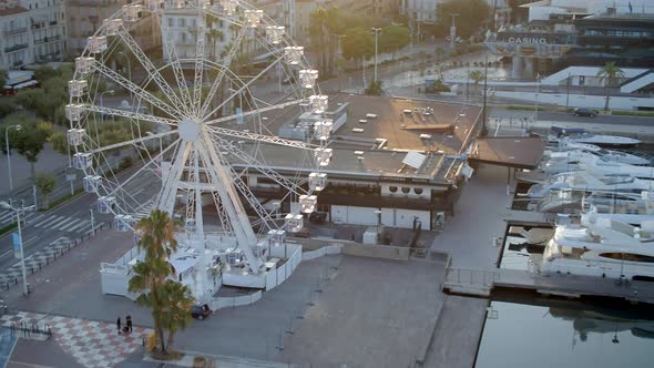 Sunrise in the Port of Cannes in France with a Ferris Wheel