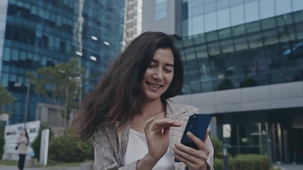 Portrait of Businesslady Chatting on Phone with Collegues