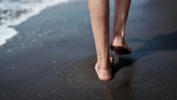 Woman Walking on the Beach During Summer Vacation, Close Up, Slow Motion of Legs and Feet Splashing