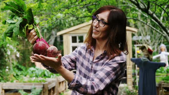 Mature woman holding beetroot vegetable