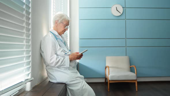 Skilled female doctor in white uniform consults patient