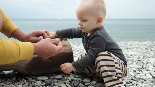 Father and Little Son Spend Time on the Beach