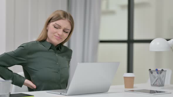 Young Woman Having Back Pain While Using Laptop 