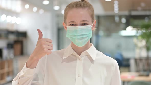 Portrait of Young Businesswoman with Face Mask Showing Thumbs Up