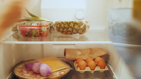 Housewife Unpacking Bag with Groceries Putting Meal in Refrigerator After Shopping on Store