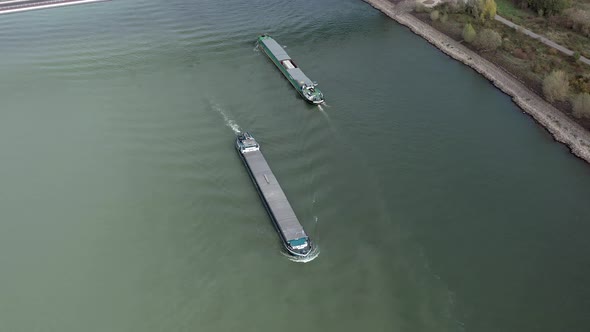 Barges Passing Under a Cable Stayed Suspension Bridge With Vehicles Crossing