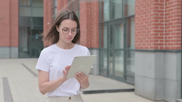 Walking Woman Using Digital Tablet