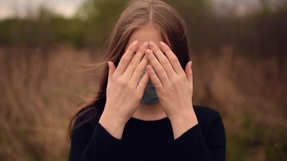 Woman in a Medical Mask Closes and Opens Face with Hands Pandemic Covid19 Coronavirus